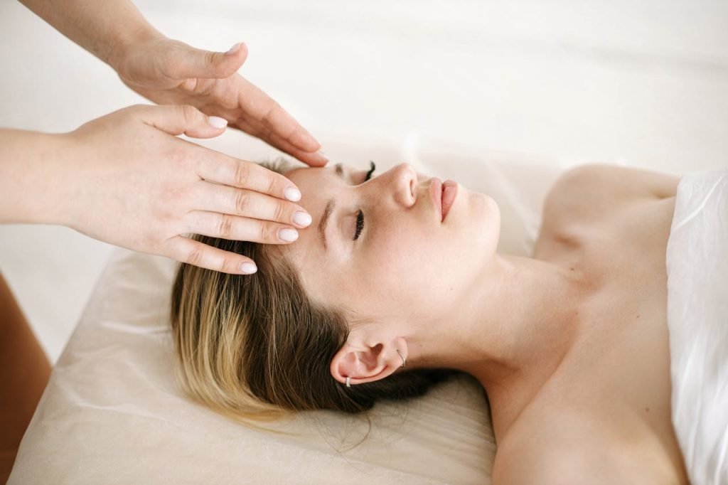 woman-having-a-face-massage-5659014 A woman enjoying a relaxing face massage at a spa for therapeutic benefits.